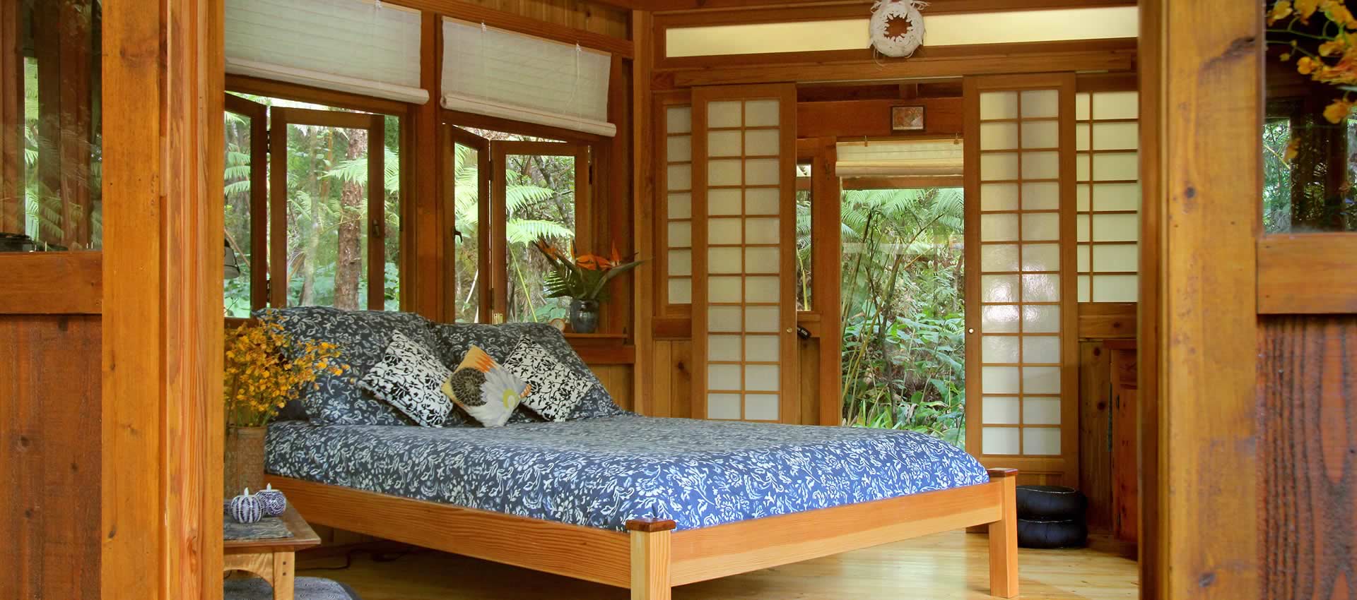 Sanctuary Cottage queen bed with indigo bedding and floor cushions