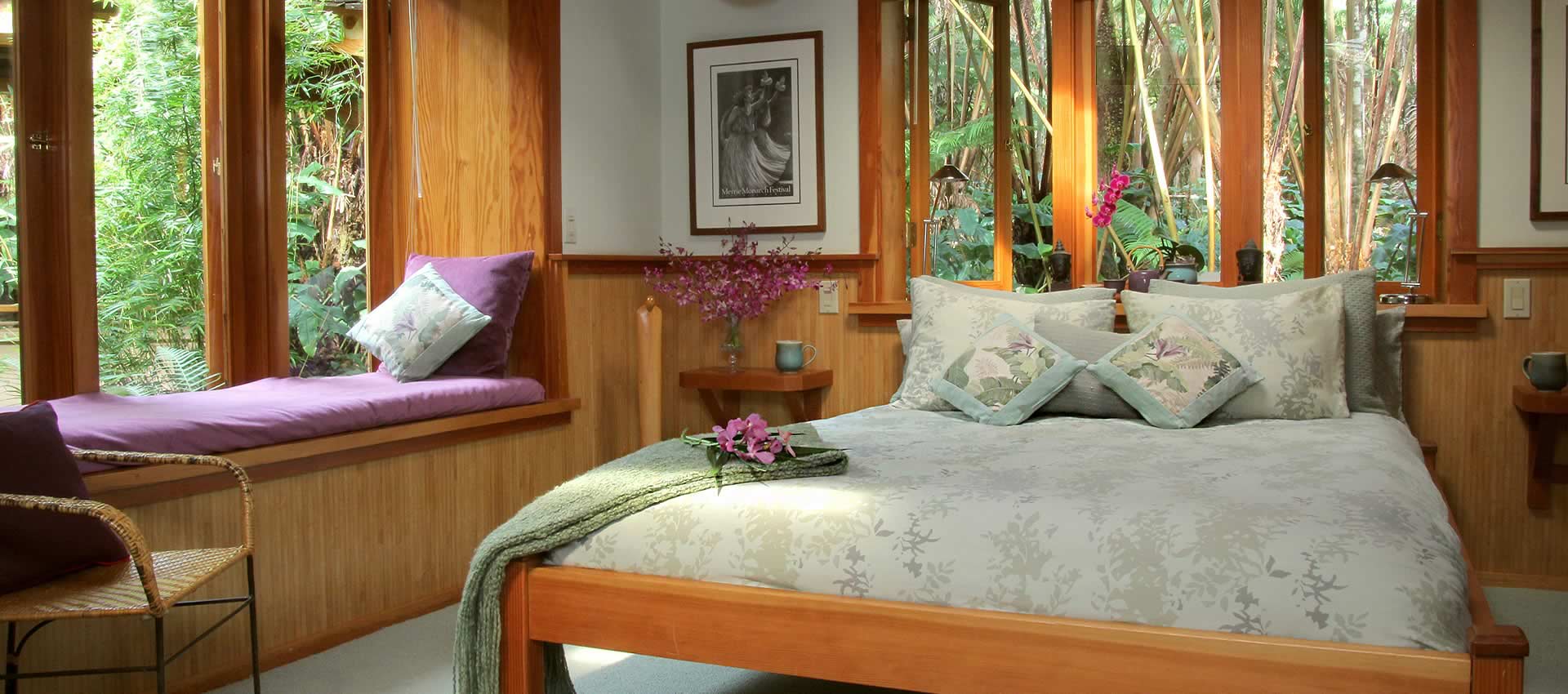Bamboo Guest House bedroom with queen bed and window seat.