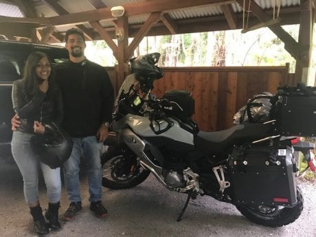 couple standing next to motorcycle